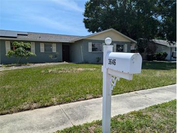 Charming one-story home with a green lawn and neatly trimmed shrubs, complemented by a white mailbox at 3646 Lakewood Dr, Sarasota, FL 34232