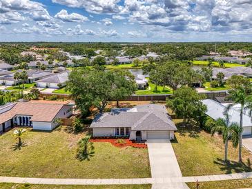 Charming single-story home with well-maintained landscaping and a long driveway in a lush, green neighborhood at 4155 Center Gate Blvd, Sarasota, FL 34233
