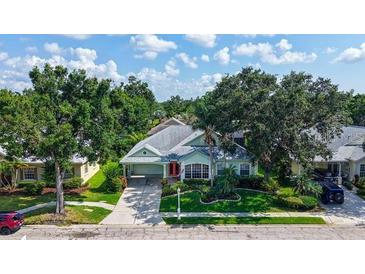 Charming single-story home with lush landscaping, well-manicured lawn, mature trees, and inviting curb appeal at 4612 4Th E Ave, Bradenton, FL 34208