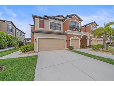 Stunning two-story townhome with attached two car garage and well-manicured lawn at 5191 78Th St E Cir, Bradenton, FL 34203