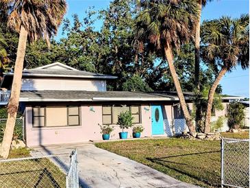 Charming single-Gathering home with a vibrant blue front door and beautiful tropical landscaping at 5439 3Rd E St, Bradenton, FL 34203