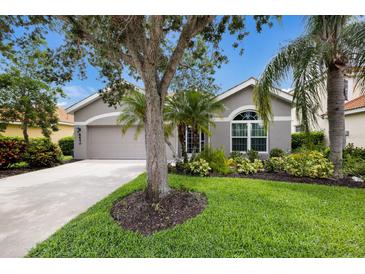 Charming single-story home featuring a manicured lawn and a two-car garage at 8640 Stone Harbour Loop, Bradenton, FL 34212