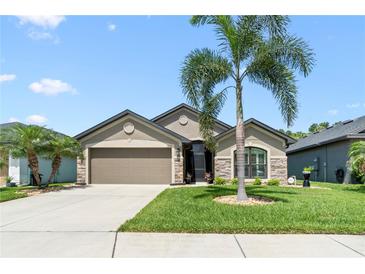 Charming one-story home featuring manicured landscaping, a two-car garage and a well-maintained lawn at 9229 52Nd E Ave, Palmetto, FL 34221