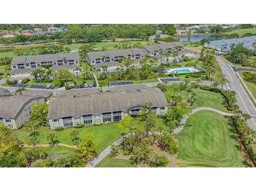 Scenic aerial view of condo community with pool, golf course, and lush landscaping at 9540 High Gate Dr # 1422, Sarasota, FL 34238