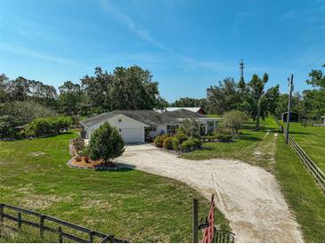Expansive ranch-style home featuring a white gravel driveway and well-maintained landscaping at 16918 Waterline Rd, Bradenton, FL 34212