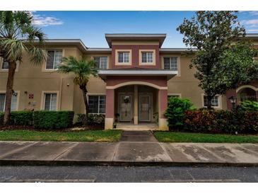 Townhouse exterior featuring well-maintained landscaping, an appealing archway entrance, and a neutral color scheme at 3707 45Th W Ter # 104, Bradenton, FL 34210