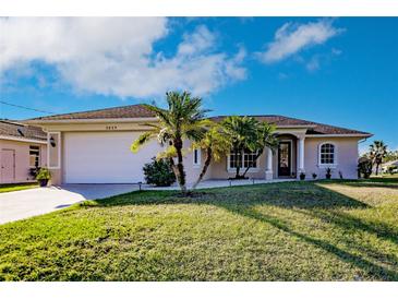 Charming single-story home with well-manicured lawn and tropical landscaping, freshly painted at 3835 W Price Blvd, North Port, FL 34286