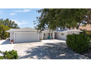 Charming single-story home with a two-car garage, driveway, and inviting front porch at 417 Park Lane Dr, Venice, FL 34285