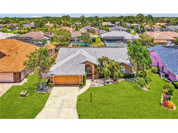 Charming single-story home featuring a well-manicured lawn, a two-car garage, and inviting curb appeal at 5742 39Th Street E Cir, Bradenton, FL 34203