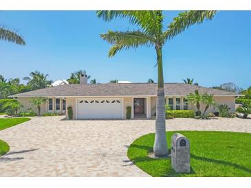 Stunning single story home with a brick driveway, manicured landscaping, and a pristine two car garage at 7913 19Th Avenue W Dr, Bradenton, FL 34209