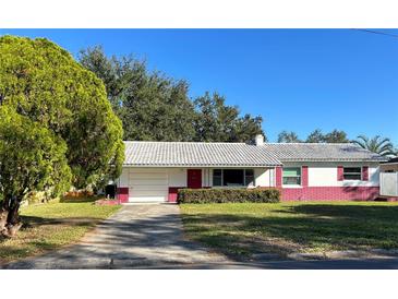 Charming single-story home with a well-manicured lawn and a vibrant exterior paint scheme at 2833 62Nd N St, St Petersburg, FL 33710