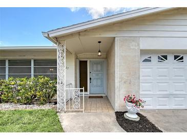 Charming entryway with decorative door, well-maintained landscaping, and attached garage at 3127 Dawson St, Sarasota, FL 34239