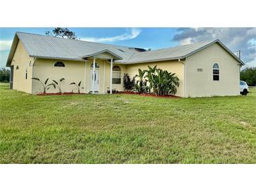 Charming single-story home with manicured lawn and lush landscaping around the front entrance at 4353 Hidden River Rd, Sarasota, FL 34240