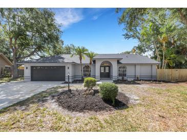 Charming single-story home featuring a well-manicured front yard and attached two-car garage at 4473 Diamond S Cir, Sarasota, FL 34233