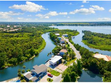 Beautiful waterfront home with stunning aerial views of the surrounding waterways and lush landscapes at 6406 Lincoln Rd, Bradenton, FL 34203