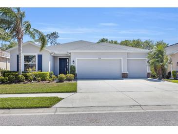 Charming one-story home with a three-car garage, well-manicured lawn, and lush landscaping at 15508 High Bell Pl, Bradenton, FL 34212