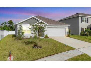Charming single-Gathering home featuring a well-maintained lawn and an attached two-car garage at 2105 Grand Flora Trl, Bradenton, FL 34208