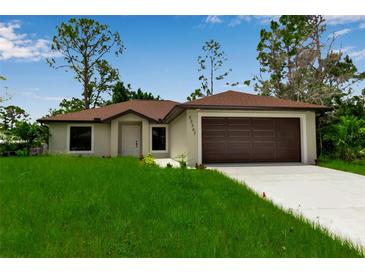 Charming one-story home boasts a well-manicured lawn, attached garage, and inviting curb appeal at 23367 Mayville Ave, Punta Gorda, FL 33980