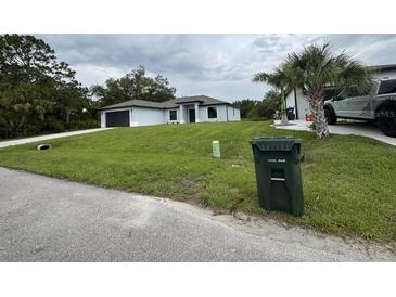 A beautifully landscaped front yard and modern single-story home at 3387 Tupelo Ave, North Port, FL 34286