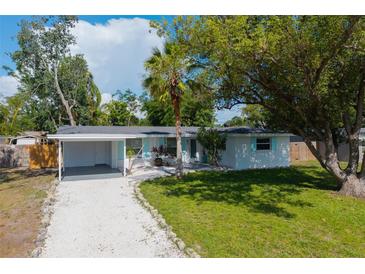 Charming single-story home with a well-manicured lawn and a convenient carport at 3975 Coleridge Pl, Sarasota, FL 34241