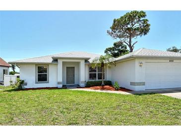 Charming single-story home with a well-maintained lawn, mature trees, and an attached two-car garage at 4484 Tortoise Rd, Venice, FL 34293