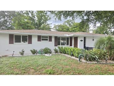 Charming single-story home featuring a well-manicured lawn, updated landscaping, and a welcoming facade at 5325 Murdock Ave, Sarasota, FL 34231