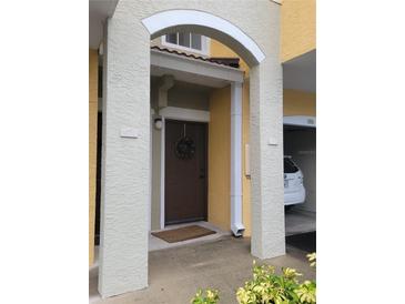 Welcoming front entrance featuring an arched entryway and decorative wreath on the door at 5459 Bentgrass Dr # 2-116, Sarasota, FL 34235