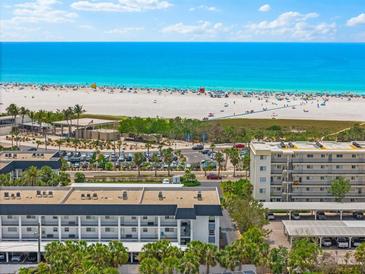Expansive beach view from a condo, with turquoise water, white sand, and a clear, sunny sky at 5600 Beach Way Dr # 201, Sarasota, FL 34242