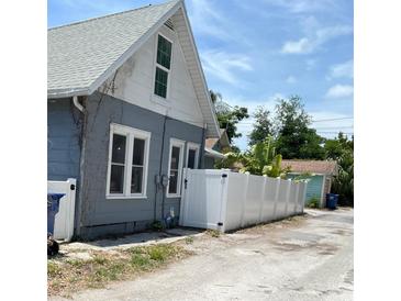 Exterior view of blue home with a white fence at 783 30Th N Ave, St Petersburg, FL 33704