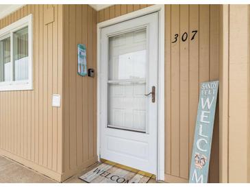Charming condo entrance with welcoming decor and exterior unit number at 150 Harborside Ave # 307, Punta Gorda, FL 33950