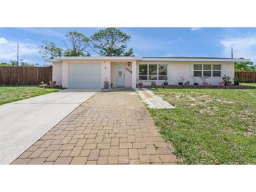 Charming single-story home featuring a well-maintained lawn and inviting brick walkway at 2524 Tuttle Way, Sarasota, FL 34239