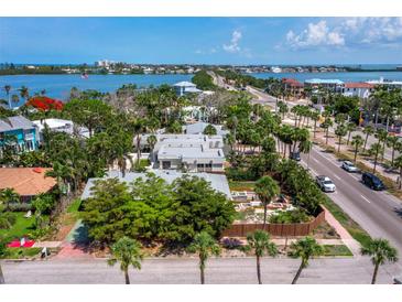 Stunning aerial view of a waterfront property showcasing lush landscaping and neighborhood charm at 335 Arthur Dr, Sarasota, FL 34236