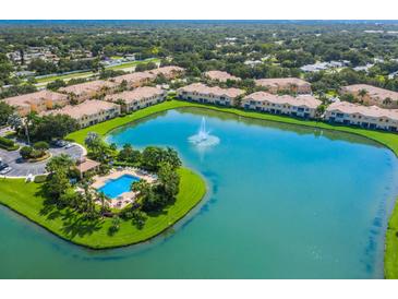 An aerial view of the community lake and pool at 3402 Parkridge Cir, Sarasota, FL 34243