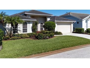 Charming single-story home boasts a well-manicured lawn and beautiful landscaping at 4257 Hearthstone Dr, Sarasota, FL 34238