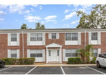 Brick two-story condominium building with a white door and white framed windows at 4507 9Th W St # A2, Bradenton, FL 34207