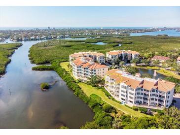 Beautiful aerial view showcasing the condo's waterfront location and lush surroundings at 5450 Eagles Point Cir # 404, Sarasota, FL 34231