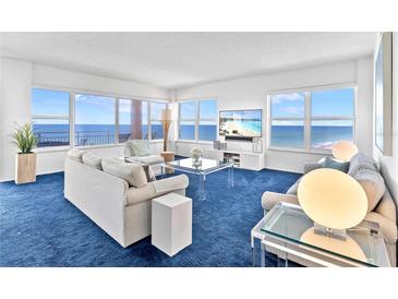 Bright living room with ocean views from large windows and modern furnishings at 601 Longboat Club Rd # 504S, Longboat Key, FL 34228