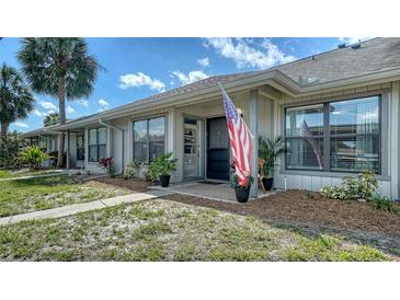 Charming single-story home featuring a cozy porch and lush landscaping at 946 N Beneva Rd # V26, Sarasota, FL 34232