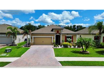Charming single-story home boasts manicured lawn, brick paver driveway, and colorful landscaping at 3712 76Th E St, Palmetto, FL 34221