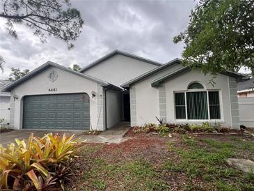 Charming single-story home features a well-maintained yard and two-car garage at 4441 Groveland Ave, Sarasota, FL 34231