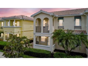Beautiful two-story home featuring balconies, arched windows, and lush landscaping at 5368 Eliseo St, Sarasota, FL 34238
