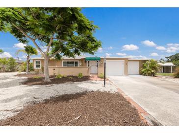 Charming single-story home with manicured front yard, shade tree, and driveway leading to a two-car garage at 715 Fontana Ln, Bradenton, FL 34209