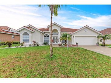 Charming single-story home with a well-manicured lawn and a beautiful red tile roof at 7327 38Th Court East, Sarasota, FL 34243