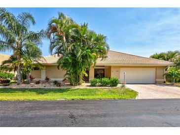 Charming single-story home with a two-car garage, beautiful landscaping, and a well-maintained front yard at 105 Inlets Blvd # 105, Nokomis, FL 34275