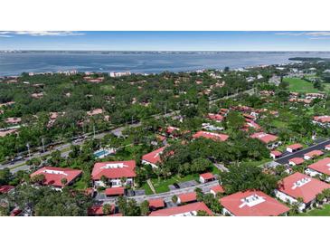 A bird's-eye view of the neighborhood, showcasing the lush landscaping and proximity to the bay at 3500 El Conquistador Pkwy # 128, Bradenton, FL 34210