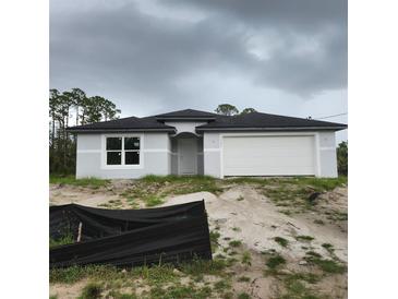 Single-story home featuring a two-car garage, a neutral color scheme, and a simple yet elegant facade at 3542 Eldron Ave, North Port, FL 34286