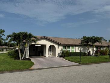 Charming single-story home with tropical landscaping, covered carport, and well-maintained lawn at 3752 Collins St # 508, Sarasota, FL 34232
