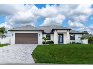 Beautiful single-Gathering home with a two-car garage, well-kept lawn, and freshly-paved driveway at 3865 Everglades Ter, North Port, FL 34286