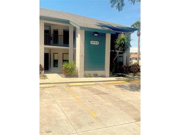 Two-story condo building with assigned parking and well-maintained landscaping at 4520 47Th W Ave # 103, Bradenton, FL 34210