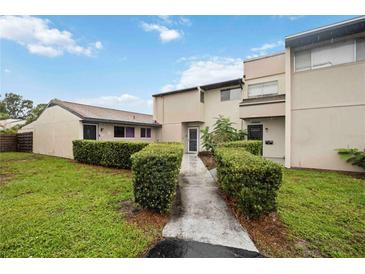 Inviting home featuring a manicured lawn, symmetrical shrubs and a well-maintained facade at 6860 Whitman Ct # 32B, Sarasota, FL 34243